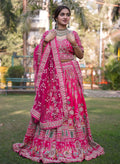 Magenta pink bridal lehenga with intricate traditional detailing, designed for an elegant and timeless bridal look.