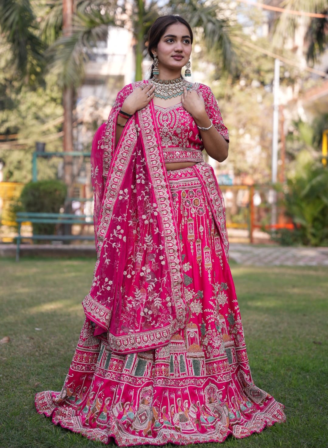 Magenta pink bridal lehenga with intricate traditional detailing, designed for an elegant and timeless bridal look.